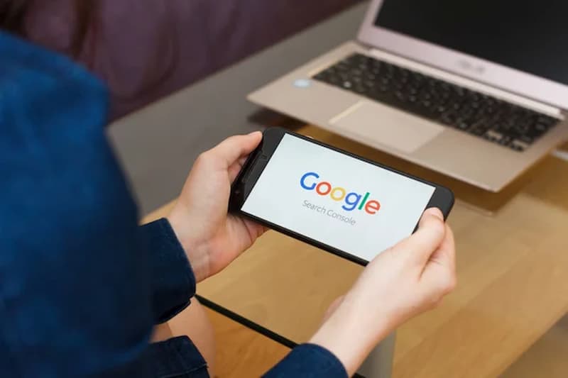 Person holding on a phone with Google on it.