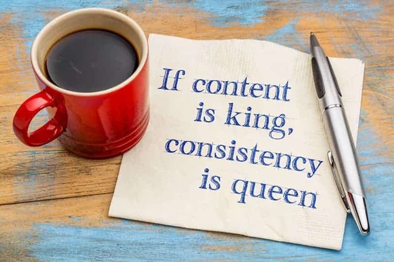 If content is king consistency is queen. Written on a napkin, with a coffee and pen.