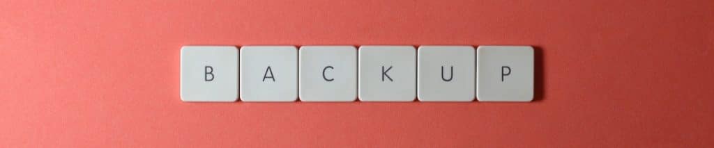 Backup written with keyboard keys on a red background