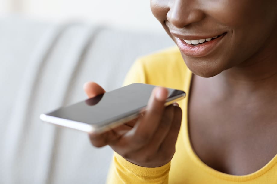 Black Woman Using Voice Assistant Option On Smartphone