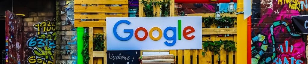 Google logo in front of colorful crates and walls